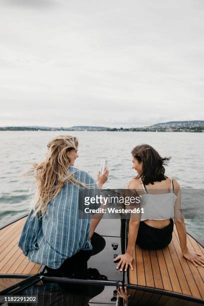 happy female friends on a boat trip on a lake - lake zurich stock pictures, royalty-free photos & images