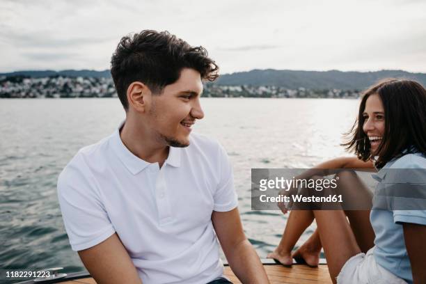 happy young couple on a boat trip on a lake - lake zurich stock pictures, royalty-free photos & images