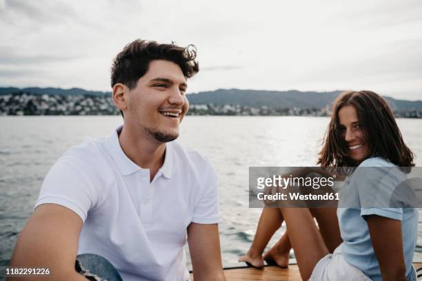 happy young couple on a boat trip on a lake - lake zurich switzerland stock pictures, royalty-free photos & images