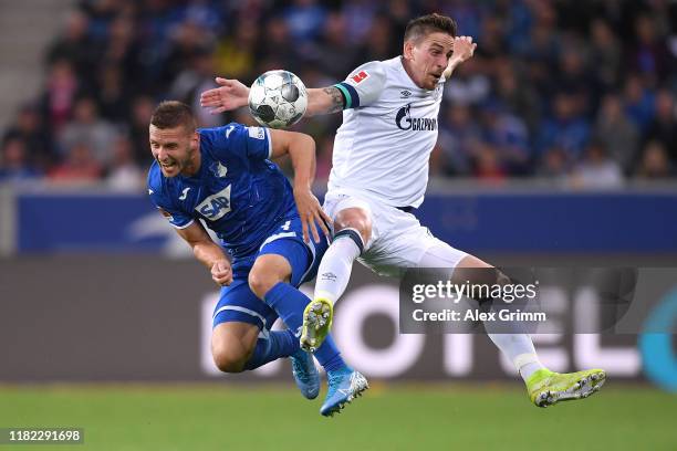 Pavel Kaderabek of Hoffenheim jumps for a header with Bastian Oczipka of Schalke during the Bundesliga match between TSG 1899 Hoffenheim and FC...