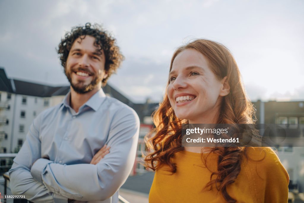 Two happy colleagues on roof terrace