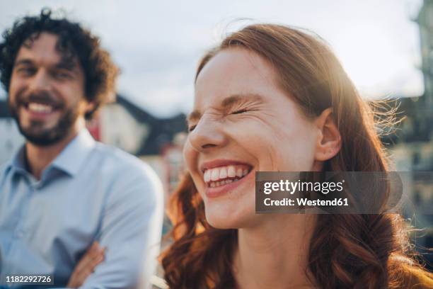 two happy colleagues on roof terrace - pareja de mediana edad fotografías e imágenes de stock