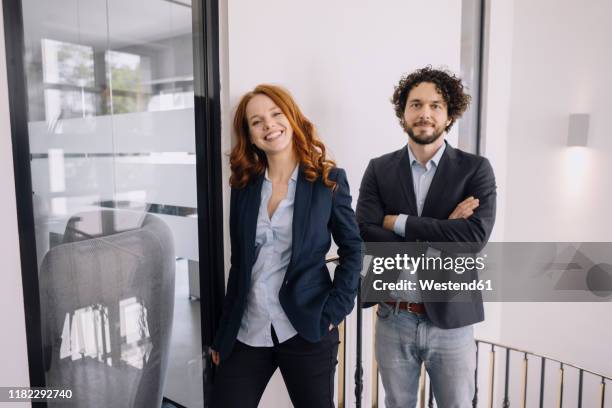 portrait of confident businessman and businesswoman in office - colleague appreciation stock pictures, royalty-free photos & images