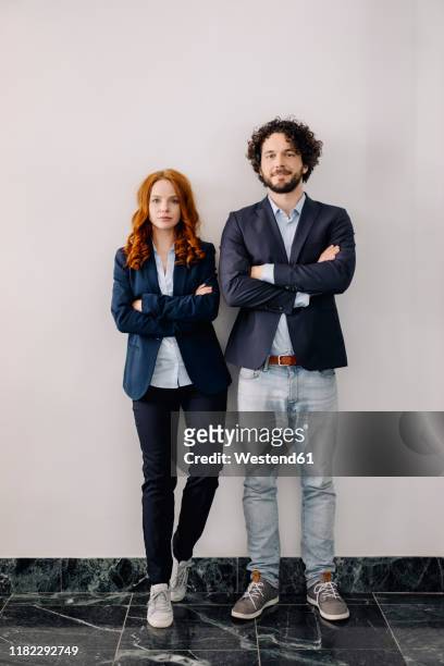 portrait of confident businessman and businesswoman standing side by side - side by side foto e immagini stock