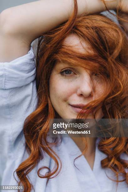 portrait of beautiful redheaded woman - beauty woman hair stock-fotos und bilder