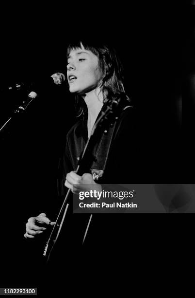 Portrait of American Folk and Pop musician Suzanne Vega plays guitar as she performs onstage at the Park West, Chicago, Illinois, February 5, 2002.
