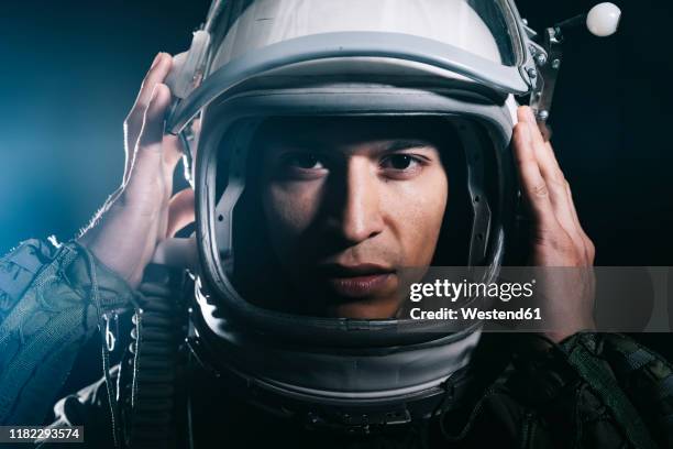 man posing dressed as an astronaut in skyrocket elevator - space helmet stock-fotos und bilder