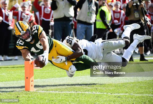 Jake Kumerow of the Green Bay Packers dives for the pylon to score a touchdown during the second quarter as Daryl Worley of the Oakland Raiders is...