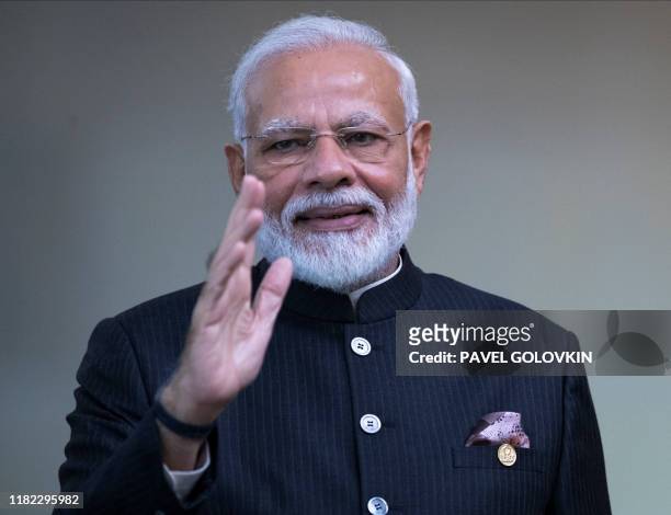 India's Prime Minister Narendra Modi waves the press before the 11th BRICS Summit at the Itamaraty palace on November 14, 2019 in Brasilia, Brazil. -...