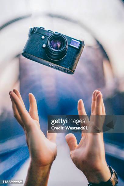 man hands throwing a vintage camera - throwing phone stock pictures, royalty-free photos & images