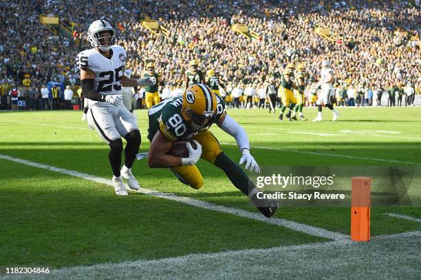 Jimmy Graham of the Green Bay Packers catches a pass for a touchdown in front of Erik Harris of the Oakland Raiders during the third quarter of a...