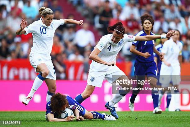 Kelly Smith and Jill Scott of England challenge Mizuho Sakaguchi of Japan during the FIFA Women's World Cup Group B match between England and Japan...