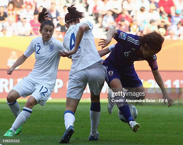 Karen Carney and Jill Scott of England fights for the ball with Mizuho Sakaguchi of Japan during the FIFA Women's World Cup 2011 group B match...