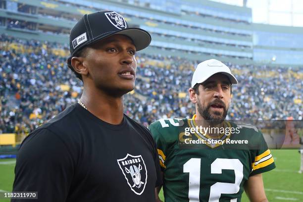 Aaron Rodgers of the Green Bay Packers speaks with DeShone Kizer of the Oakland Raiders following a game at Lambeau Field on October 20, 2019 in...