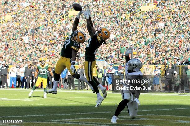 Kevin King of the Green Bay Packers makes an interception on a pass intended for Darren Waller of the Oakland Raiders in the fourth quarter at...