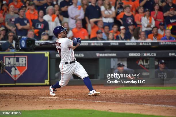 Houston Astros' second baseman Jose Altuve hits a 2-run home run to win the game in the ninth inning in Game 6 of the ALCS against the New York...