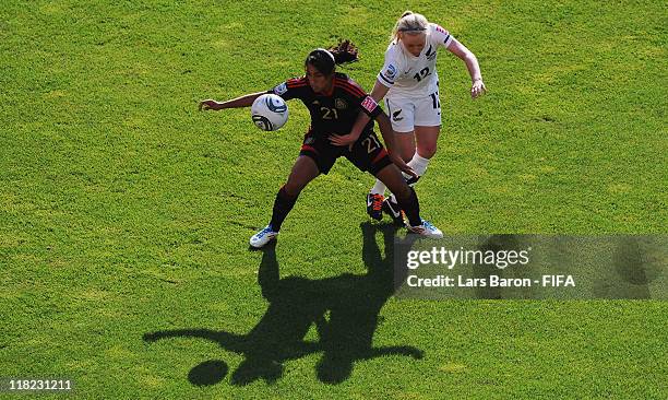 Stephanie Mayor of Mexico is challenged by Betsy Hassett of New Zealand during the FIFA Women's World Cup 2011 Group B match between New Zealand and...