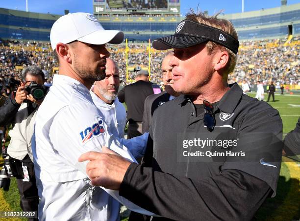 Head coach Jon Gruden of the Oakland Raiders and head coach Matt LaFleur of the Green Bay Packers shake hands after the game at Lambeau Field on...