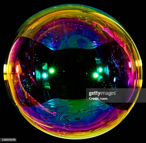 big soap bubble on black background - iridescent stockfoto's en -beelden