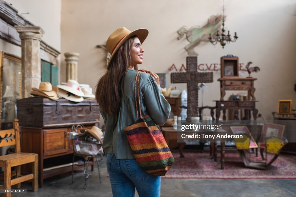 Young woman shopping in antique store