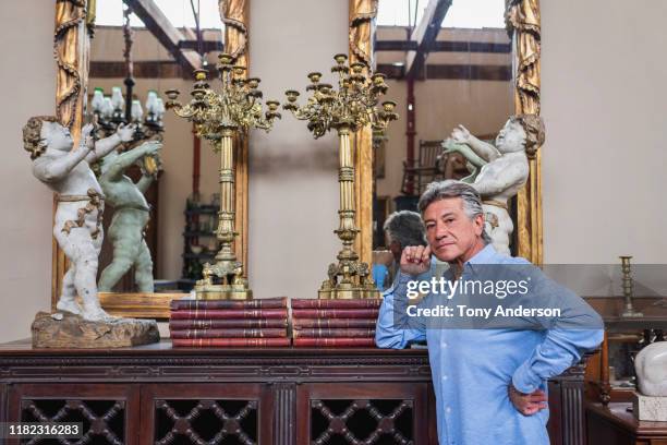 man standing in his antique store - man in antique shop stock pictures, royalty-free photos & images