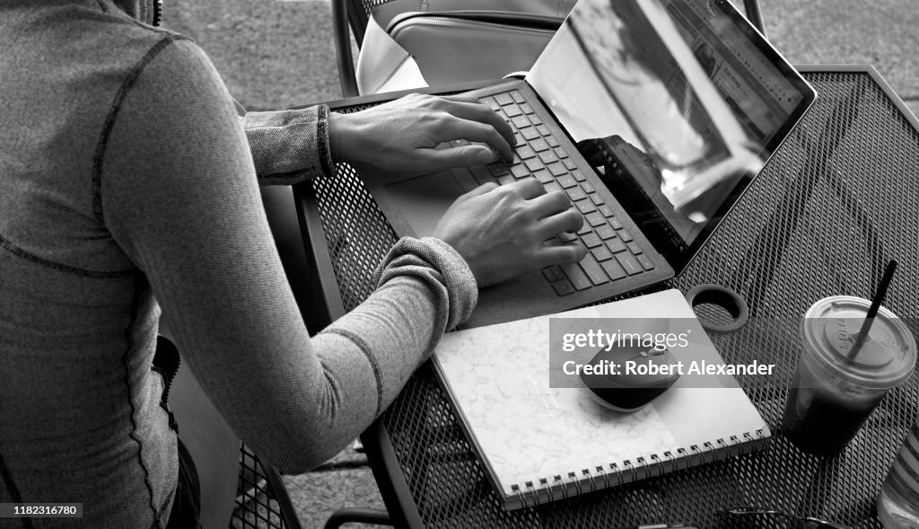 Lady Using Dell Computer A woman uses her laptop computer at an outdoor cafe in Jacksonville ...