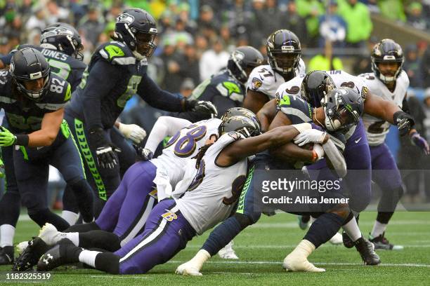 Chris Carson of the Seattle Seahawks runs the ball against the Baltimore Ravens during the first half of the game at CenturyLink Field on October 20,...