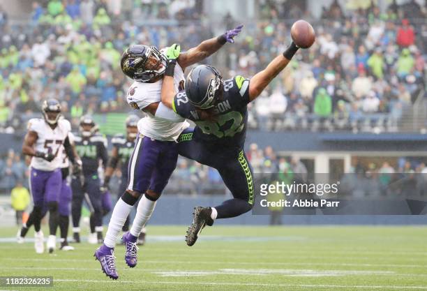 Tight end Luke Willson of the Seattle Seahawks fails to complete a pass as defensive back Chuck Clark of the Baltimore Ravens defends in the second...