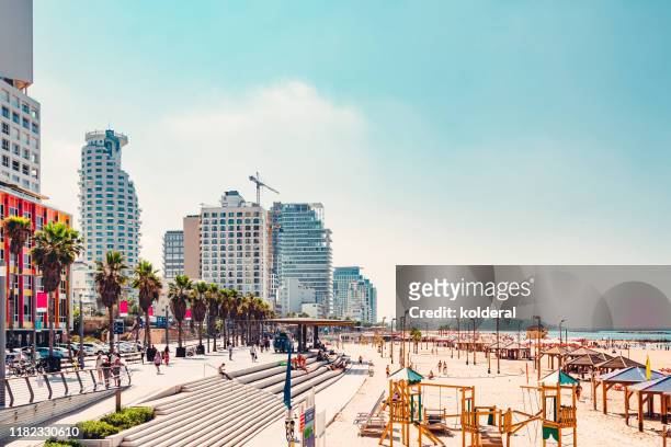 view of promenade and sandy beach in tel aviv - tel aviv photos et images de collection