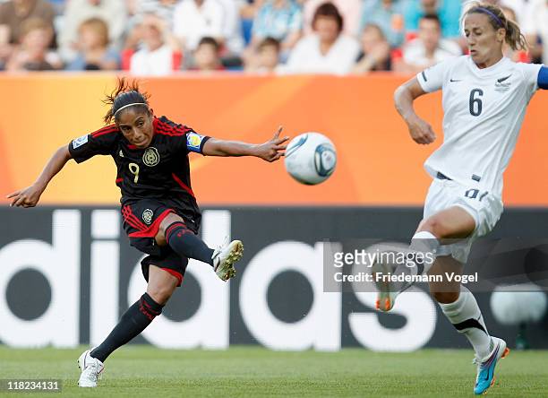 Maribel Dominguez of Mexico shoots at goal next to Rebecca Smith of New Zealand during the FIFA Women's World Cup 2011 Group B match between New...
