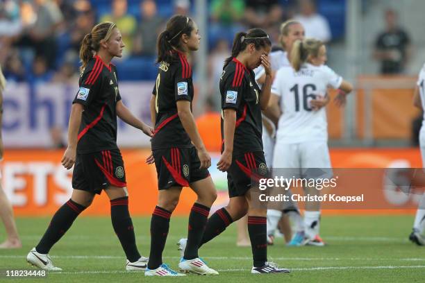 Dinora Garza, Guadalupe Worbis and Veronica Perez of Mexico look dejected after the 2-2 draw of the FIFA Women's World Cup 2011 Group B match between...