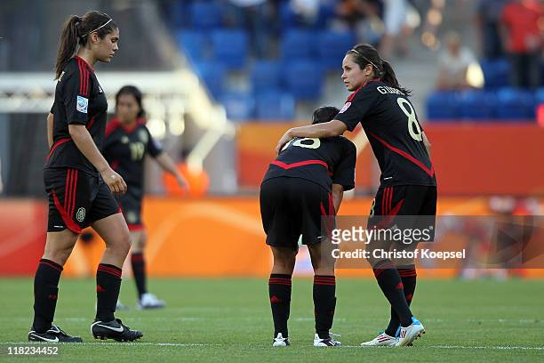 Alina Garciamendez, Veronica Perez and Guadalupe Worbis of Mexico look dejected after the 2-2 draw of the FIFA Women's World Cup 2011 Group B match...