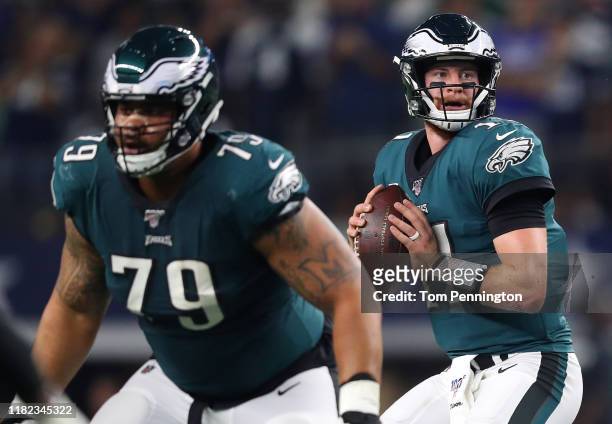 Carson Wentz of the Philadelphia Eagles looks to pass as Brandon Brooks blocks during the first half against the Dallas Cowboys in the game at AT&T...