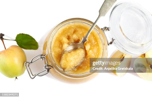 apple sauce in jars on white background - eingemacht stock-fotos und bilder