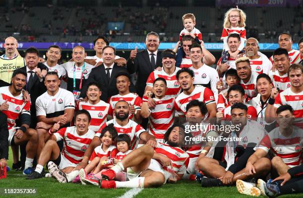 Captain Michael Leitch of Japan coach Jamie Joseph and team Japan pictured in a team group after the Rugby World Cup 2019 Quarter Final match between...