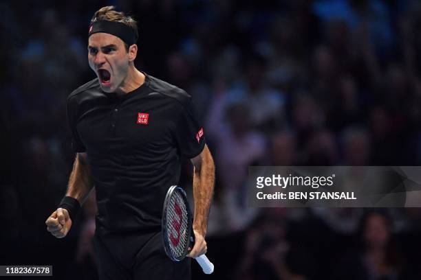 Switzerland's Roger Federer celebrates his straight sets win over Serbia's Novak Djokovic in their men's singles round-robin match on day five of the...