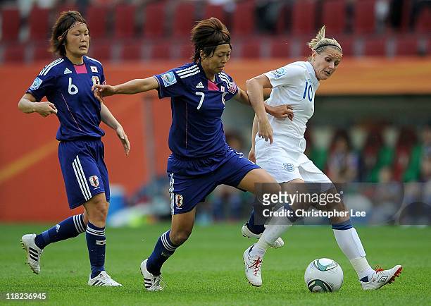 Kozue Ando of Japan battles with Kelly Smith of Engalnd during the FIFA Women's World Cup Group B match between England and Japan in Augsburg Stadium...