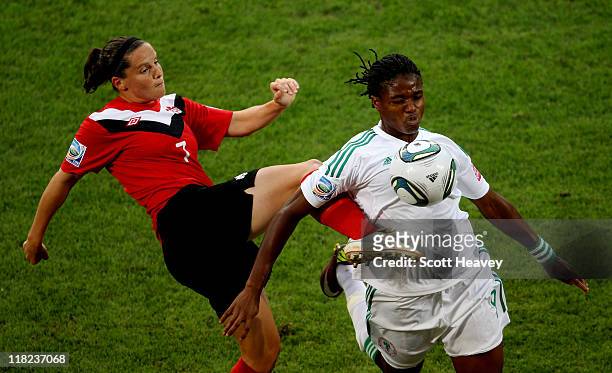 Rhian Wilkinson of Canada challenges Desire Oparanozie of Nigeria in action during the FIFA Women's World Cup 2011 Group A match between Canada and...