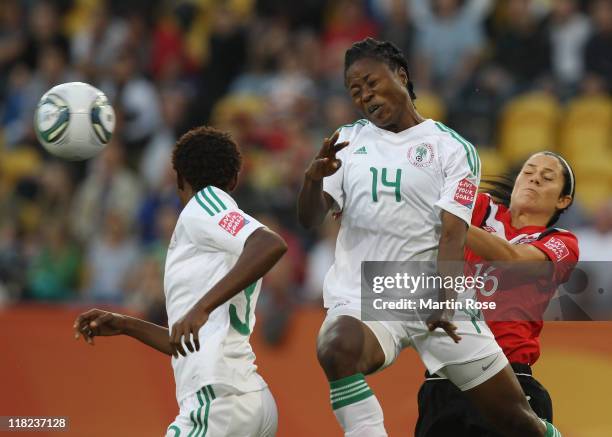 Jonelle Filigno of Canada and Faith Ikidi of Nigeria battle for the ball during the FIFA Women's World Cup 2011 Group A match between Canada and...