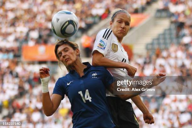 Louisa Necib of France is challenged by Babett Peter of Germany during the FIFA Women's World Cup 2011 Group A match between France and Germany at...