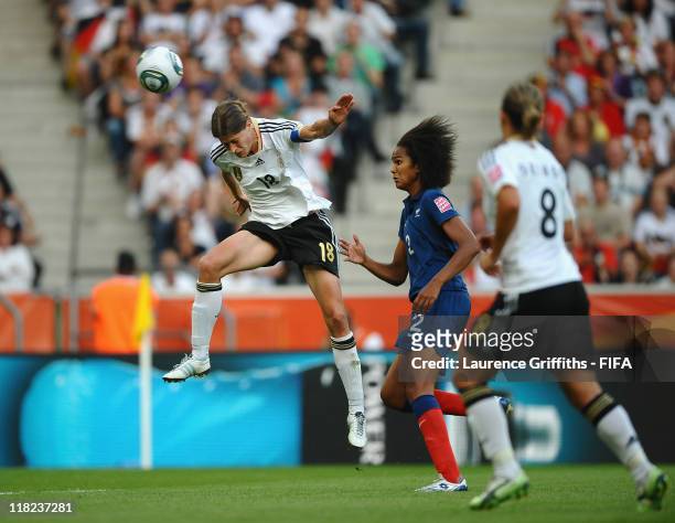 Kerstin Garefrekes of Germany rises to score the opening goal under pressure from Wendie Renard of France during the FIFA Women's World Cup 2011...