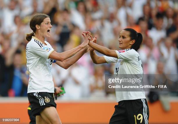 Kerstin Garefrekes of Germany celebrates scoring the opening goal with Fatmire Bajramaj during the FIFA Women's World Cup 2011 Group A match between...