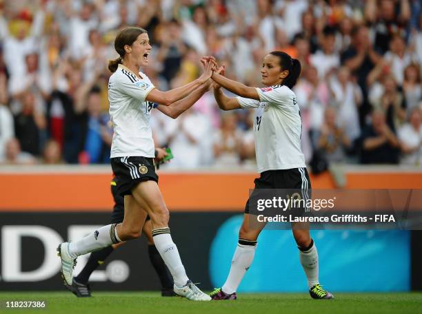 Kerstin Garefrekes of Germany celebrates scoring the opening goal with Fatmire Bajramaj during the FIFA Women's World Cup 2011 Group A match between...