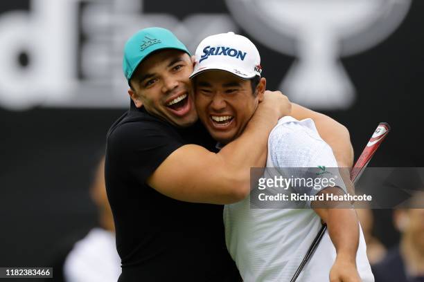 Former rugby player Bryan Habana of South Africa congratulates Hideki Matsuyama of Japan after the birdie on the 7th green during The Challenge:...