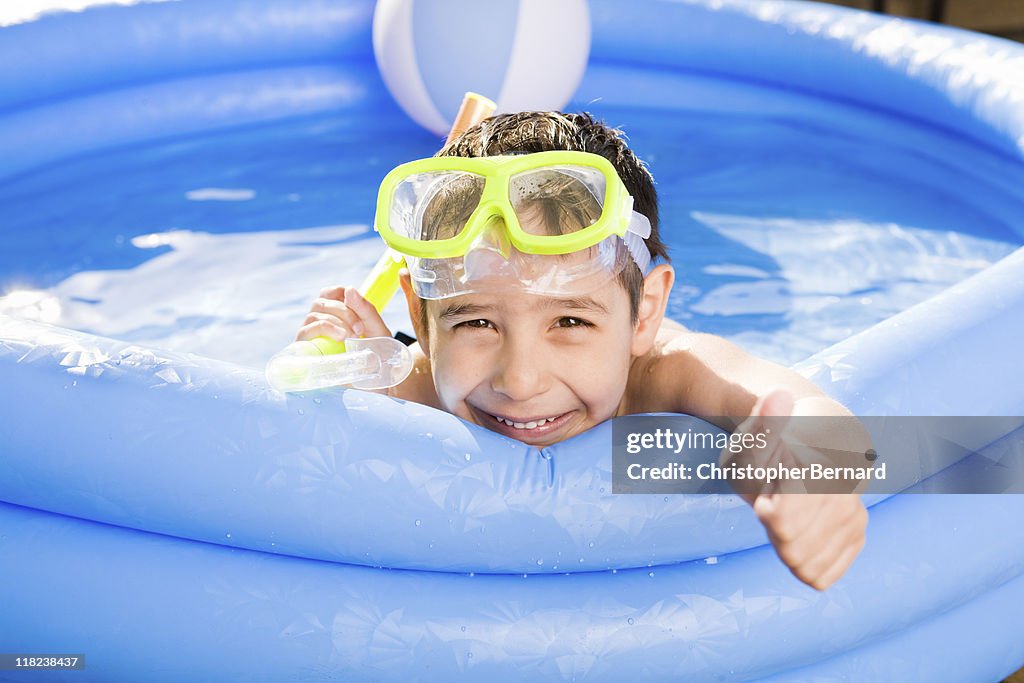 Smiling boy swimming outdoor