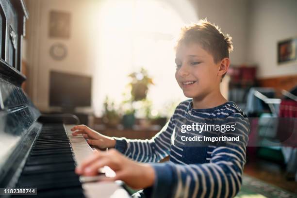 little boy enjoying playing together - pianist stock pictures, royalty-free photos & images