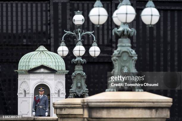 An Imperial Guard officer stands guard at a gate to the Imperial Palace as Japan prepares for the enthronement of Emperor Naruhito, which takes place...