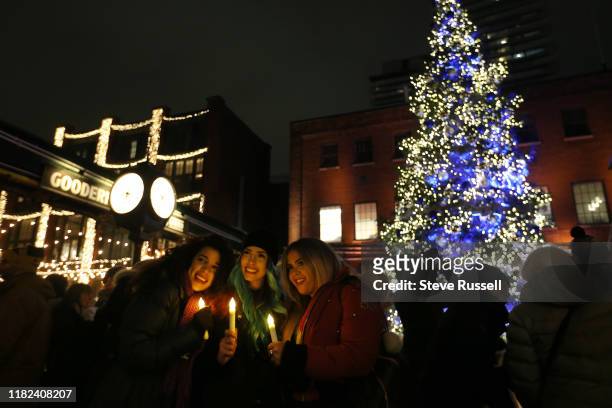 Ana Lía Arias Garrido, Natalie Rivera, Stefania Serna pose for a photo as the Toronto Christmas Market official opens for their 10th season by...
