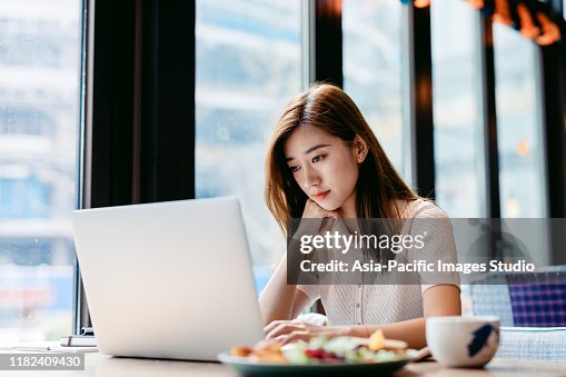 Asian woman working laptop at cafe. Asian woman working laptop at cafe.