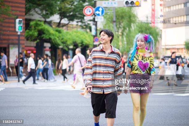 fashionable young friends walking around the city together - harajuku stock pictures, royalty-free photos & images